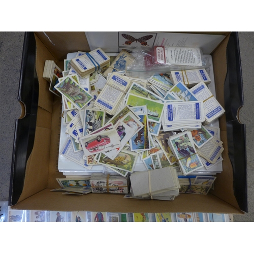 718 - Cigarette cards; a box of cigarette and trade cards, in albums and sleeves plus loose