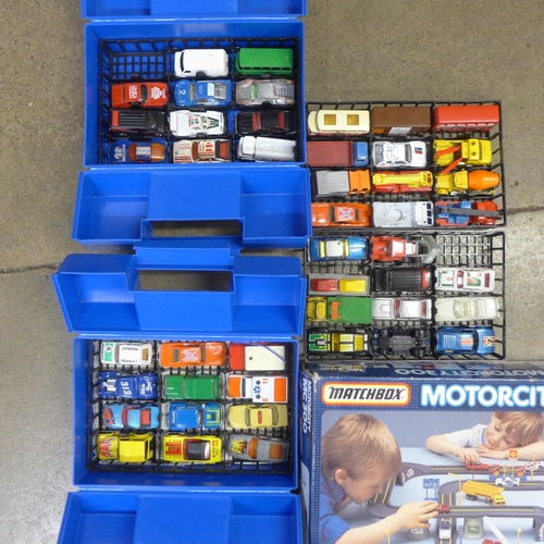 746 - A Matchbox Motorcity 300 playset and two carry cases containing model vehicles