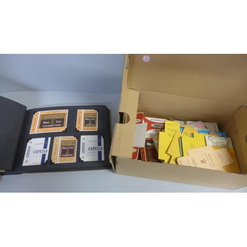 756 - A box of cigarette packets and an album of cigarette packets