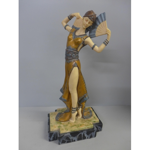 792 - A reproduction Art Deco figure of a dancer on mock marble plinth