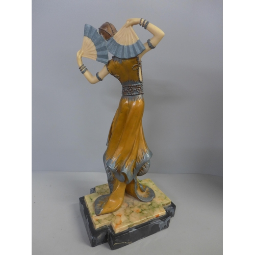 792 - A reproduction Art Deco figure of a dancer on mock marble plinth