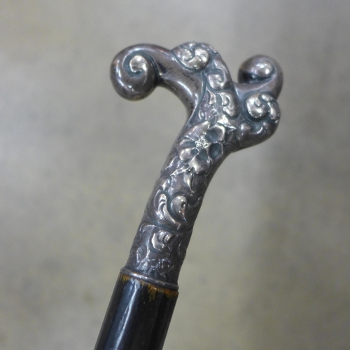 812 - An ebonised walking cane with white metal top