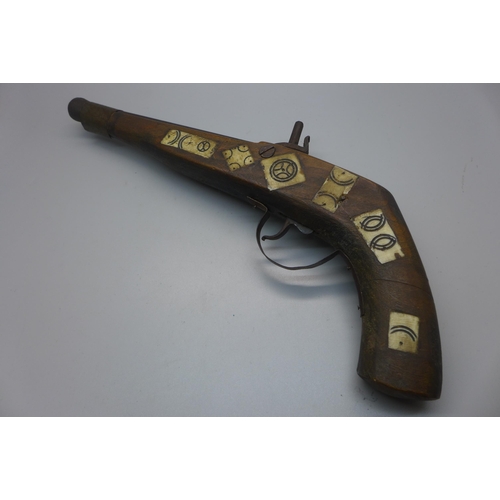 834 - A North African replica pistol with bone inlay