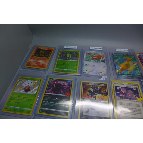 840 - Sixteen Pokemon cards including Japanese Charizard, promo, new, V-Cards, 1st Edition Magmar, etc.