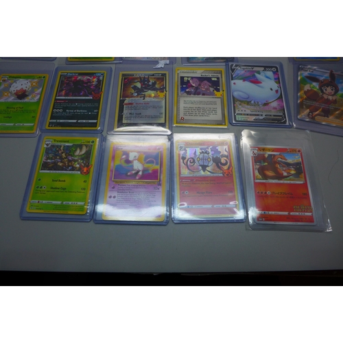 840 - Sixteen Pokemon cards including Japanese Charizard, promo, new, V-Cards, 1st Edition Magmar, etc.