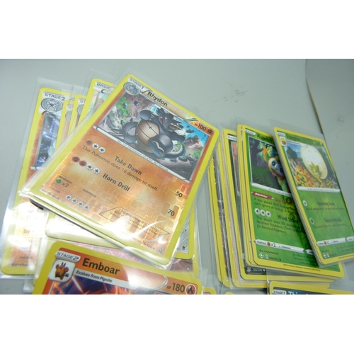 860 - Thirty holo/reverse holo and 300 common/uncommon/rare Pokemon cards in tin