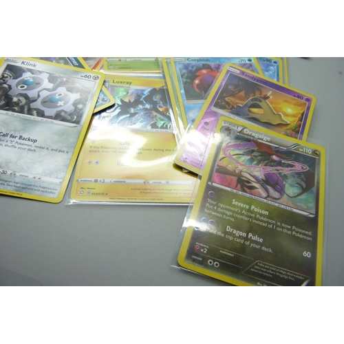 861 - Thirty holo/reverse holo and 300 common/uncommon/rare Pokemon cards in tin