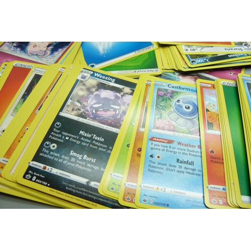 861 - Thirty holo/reverse holo and 300 common/uncommon/rare Pokemon cards in tin