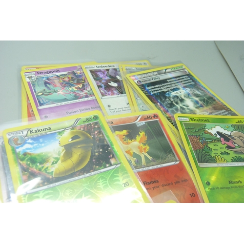 862 - Thirty holo/reverse holo and 300 common/uncommon/rare Pokemon cards in tin