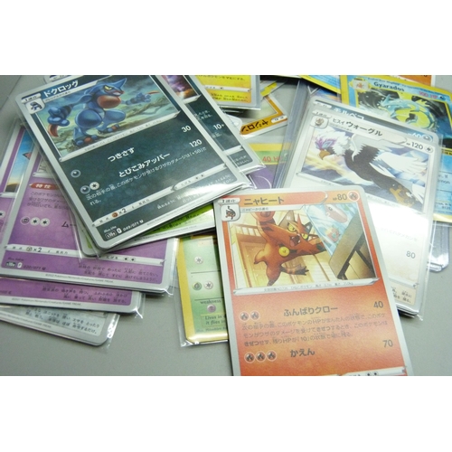 863 - Two tins of assorted Pokemon cards including holos