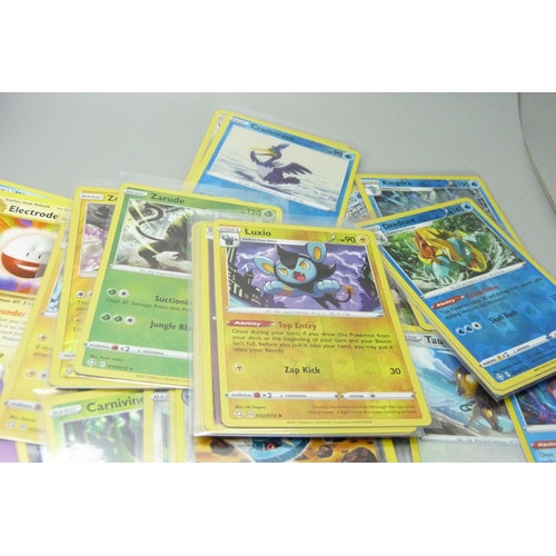 866 - Thirty holo/reverse holo and 300 common/uncommon/rare Pokemon cards in tin