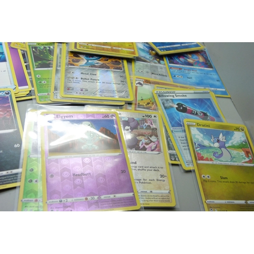 866 - Thirty holo/reverse holo and 300 common/uncommon/rare Pokemon cards in tin