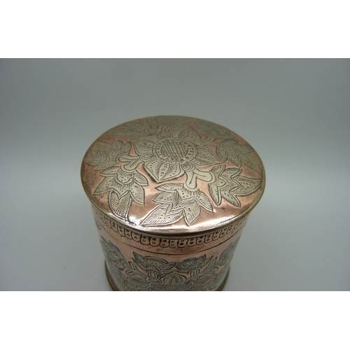 869 - An eastern copper pot with engraved decoration