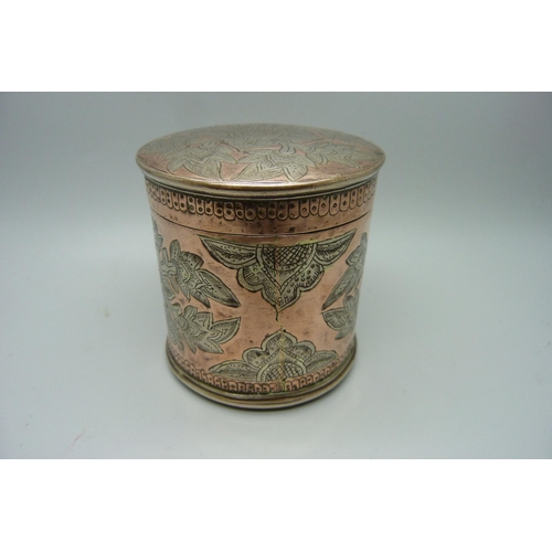 869 - An eastern copper pot with engraved decoration