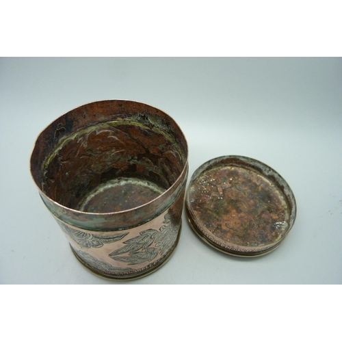 869 - An eastern copper pot with engraved decoration