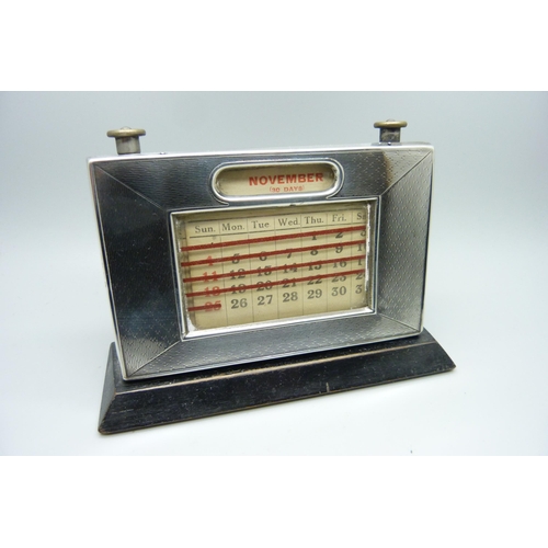 872 - A silver fronted perpetual desk calendar