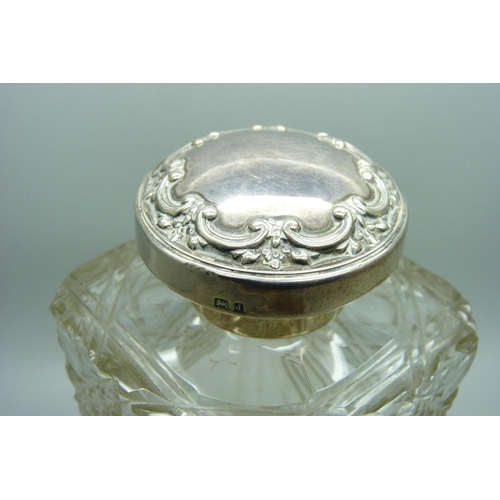 880 - A silver topped decanter with lockable top