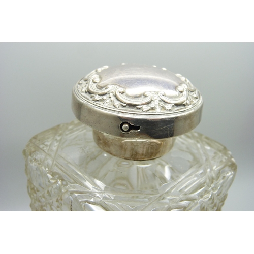 880 - A silver topped decanter with lockable top