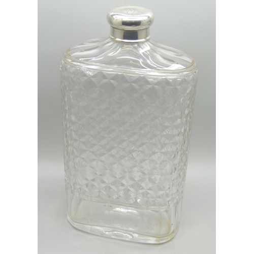 882 - A silver topped glass flask