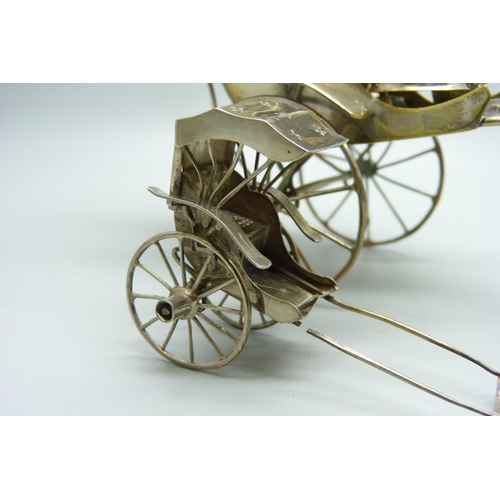 914 - A white metal cruet in the form of a rickshaw and a small Chinese silver model carriage