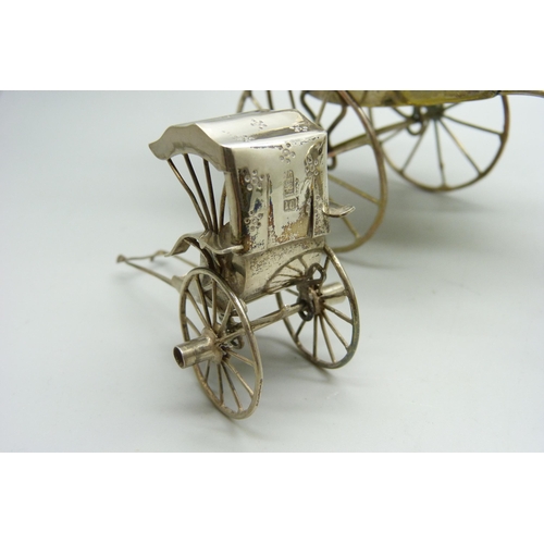 914 - A white metal cruet in the form of a rickshaw and a small Chinese silver model carriage