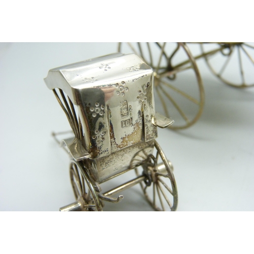 914 - A white metal cruet in the form of a rickshaw and a small Chinese silver model carriage