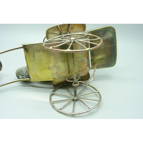 914 - A white metal cruet in the form of a rickshaw and a small Chinese silver model carriage