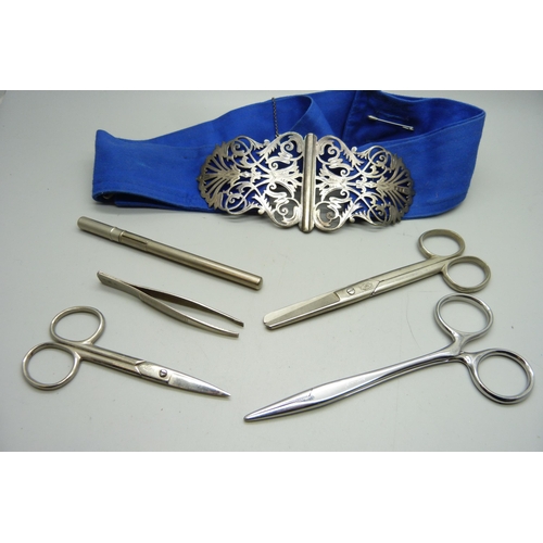 941 - A silver nurse's belt buckle with silver nursing badge, scissors, a thermometer in metal tube and tw... 