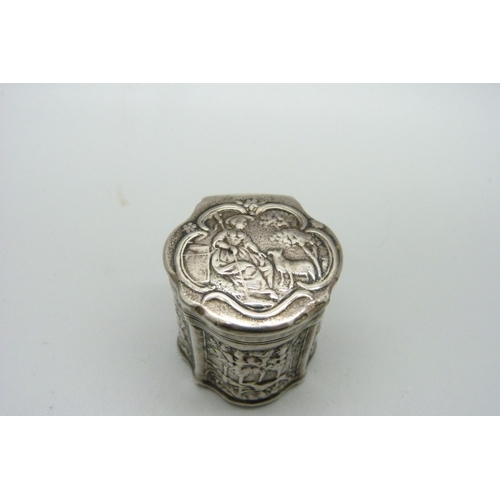 947 - A continental silver embossed box decorated with hunting scenes, 37mm