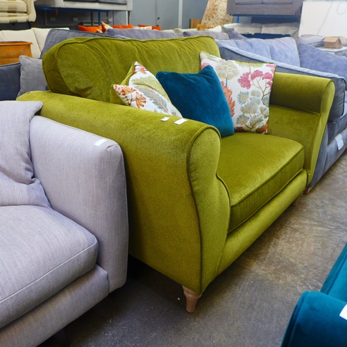 1305 - A metallic sheen green upholstered loveseat with patterned scatter cushions