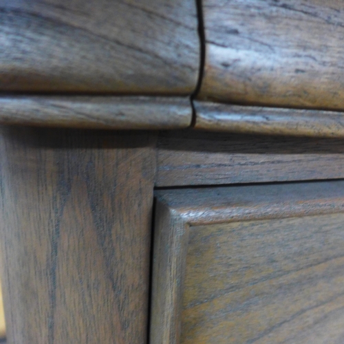 1586 - A Liberty, three drawer, bedside chest in stained oak