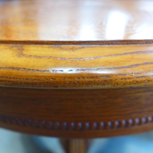 1589 - A circular wooden engraved lamp table