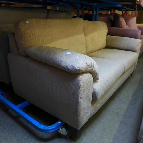 1605 - A sand upholstered three seater sofa - marked