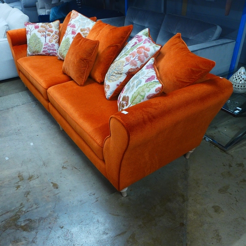 1304 - A metallic orange upholstered four seater sofa with patterned scatter cushions