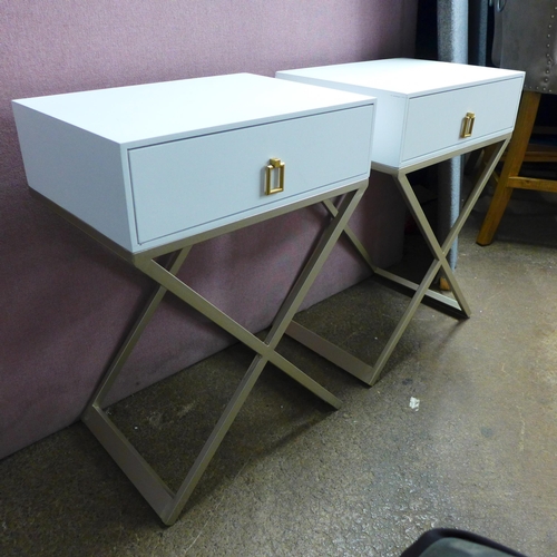 1434 - A pair of white bedside tables with cross legs, slight damage