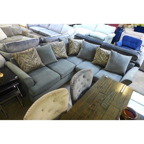 1504 - A stone upholstered corner sofa