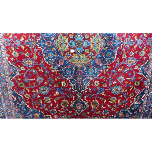 1611 - A large hand woven Persian mashad, carpet, full pile, multi-coloured floral design, 338 x 248cm