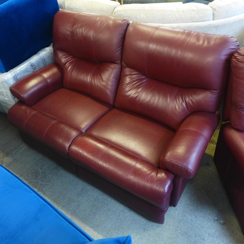 1634 - A chestnut leather two seater reclining sofa and reclining armchair