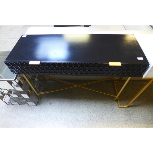 1646 - A black console table with gold legs, missing some bolts