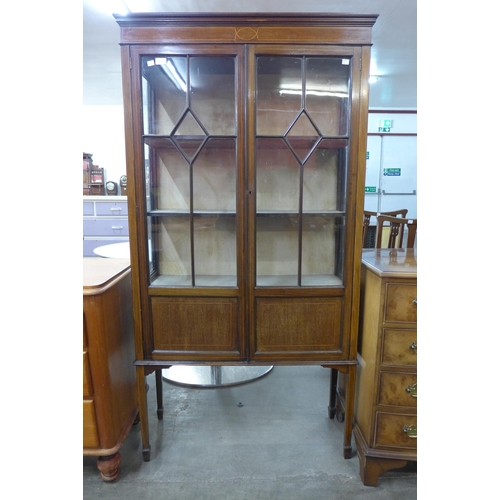 112 - An Edward VII inlaid mahogany two door display cabinet