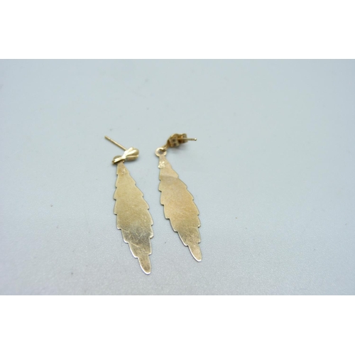 1021 - A pair of yellow metal drop earrings, 0.9g, one stem bent