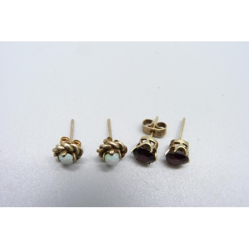 1027 - A pair of yellow metal and opal ear studs and a pair of yellow metal and garnet ear studs, total wei... 