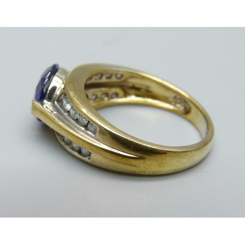 1053 - A silver gilt, blue and white stone ring, M