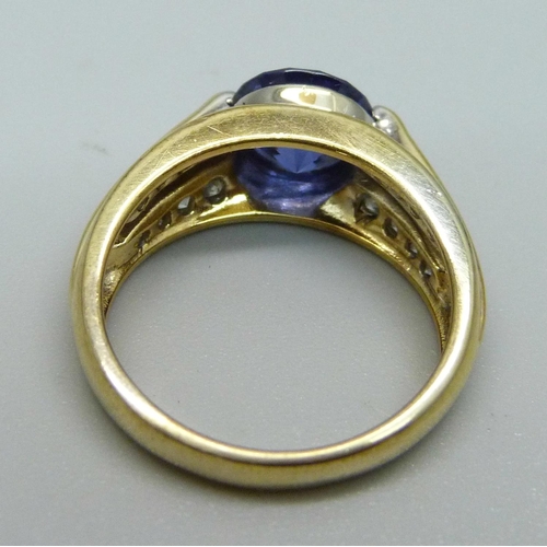 1053 - A silver gilt, blue and white stone ring, M