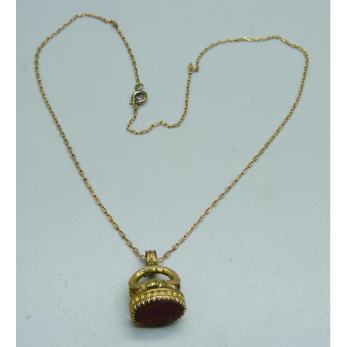 1063 - A yellow metal chain with a plated fastener and a plated seal fob