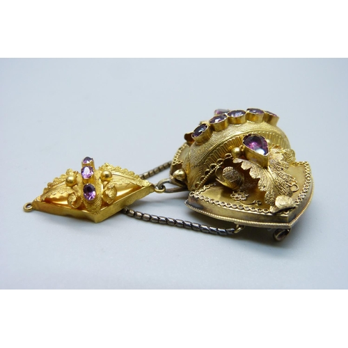 1087 - A Victorian yellow metal brooch set with amethysts, (tests as 14ct gold), with a case, 8.5g