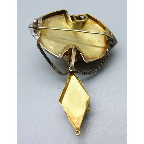 1087 - A Victorian yellow metal brooch set with amethysts, (tests as 14ct gold), with a case, 8.5g