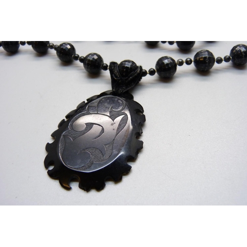 1095 - A jet pendant on a black bead necklace