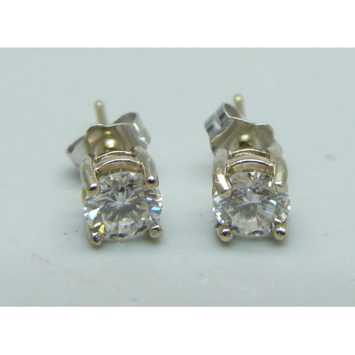 1111 - A pair of 18ct white gold and diamond stud earrings, approximately 0.90ct weight