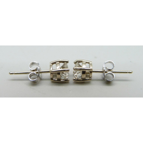 1111 - A pair of 18ct white gold and diamond stud earrings, approximately 0.90ct weight